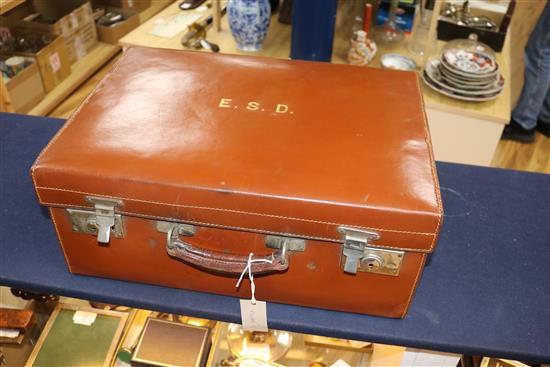 A leather travelling toilet case containing four late Victorian silver mounted jars and thirteen tortoiseshell mounted items.